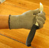 Cut Resistant Glove Holding 8 Inch Butcher Knife -  Click on the Photo to Englarge